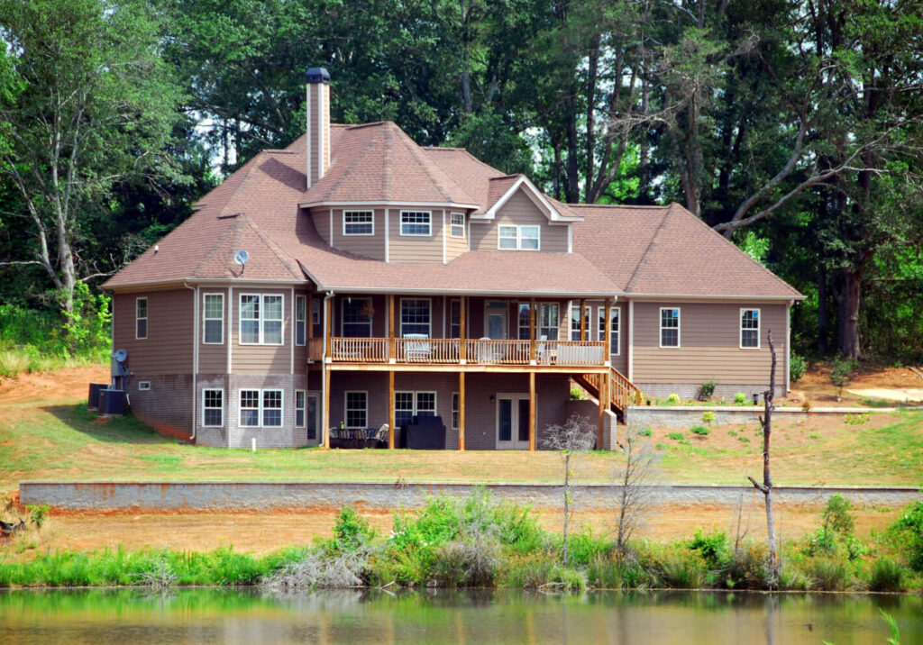 A big home in front of a lake